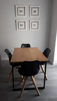 a wooden table with four chairs in a room at Sanlucar-Centro in Sanlúcar de Barrameda
