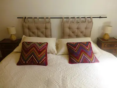 a bedroom with a bed with two pillows on it at Casa Isabela in Chiclana de la Frontera