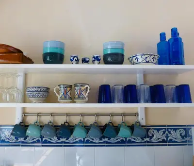 a shelf filled with blue and white ceramics at Casa Isabela in Chiclana de la Frontera