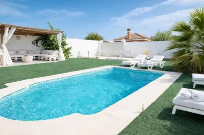 a swimming pool in the backyard of a villa at PuraVidaChiclana in Chiclana de la Frontera