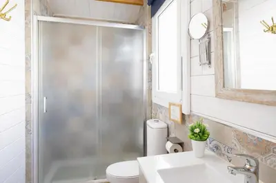 a bathroom with a shower and a toilet and a sink at PuraVidaChiclana in Chiclana de la Frontera