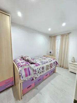 a bedroom with a bed and a mirror in it at Apartamento Centro Cabildo in Sanlúcar de Barrameda