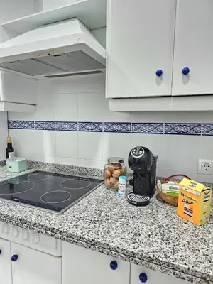 a kitchen with a counter top with a toaster on it at Apartamento Centro Cabildo in Sanlúcar de Barrameda