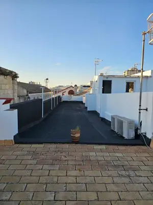 a parking lot with a potted plant on a building at Apartamento Centro Cabildo in Sanlúcar de Barrameda