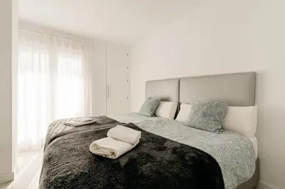 a bedroom with a large bed with two towels on it at Bahía Encanto in El Puerto de Santa María