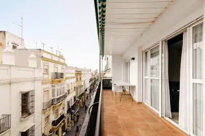 an apartment balcony with a view of a city at Bahía Encanto in El Puerto de Santa María