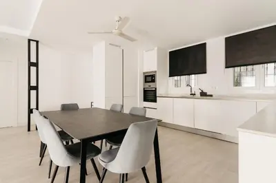 a kitchen with a dining room table and chairs at Bahía Encanto in El Puerto de Santa María