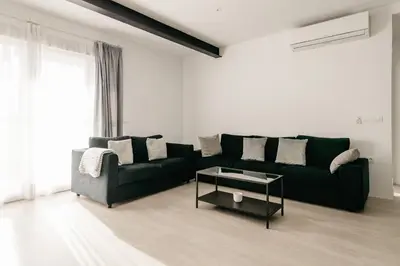 a living room with a black couch and a table at Bahía Encanto in El Puerto de Santa María
