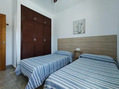 two beds sitting next to each other in a bedroom at Casa Ramos in Conil de la Frontera