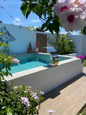 a swimming pool in a garden with flowers at Let´s go to Valhalla in Chiclana de la Frontera