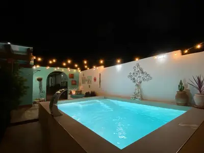 a swimming pool in a house at night at Let´s go to Valhalla in Chiclana de la Frontera