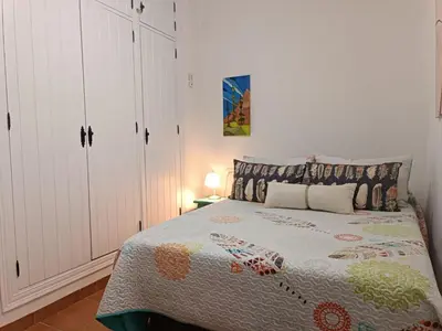 a bedroom with a bed and white cabinets at Let´s go to Valhalla in Chiclana de la Frontera