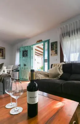 a bottle of wine sitting on a table with a wine glass at Let´s go to Valhalla in Chiclana de la Frontera