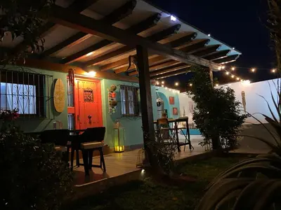 a patio with a table and chairs under a pergola at Let´s go to Valhalla in Chiclana de la Frontera