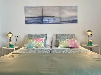 a bed with two pillows on it in a room at GINVA - Casa palacio La Templanza in El Puerto de Santa María