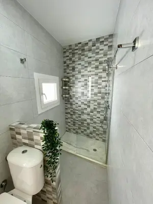 a bathroom with a shower and a toilet and a glass shower at GINVA - Casa palacio La Templanza in El Puerto de Santa María
