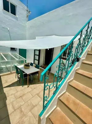 a balcony with a table and a table and stairs at GINVA - Casa palacio La Templanza in El Puerto de Santa María