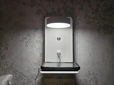 a laptop on a wall with a light on it at El Anfitrión - Palacio Argüeso in Sanlúcar de Barrameda