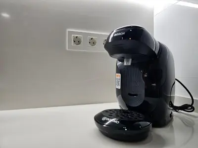 a black coffee maker sitting on top of a counter at El Anfitrión - Palacio Argüeso in Sanlúcar de Barrameda
