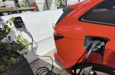 an electric car is plugged into a charger at Casa Pedro Luis in Conil de la Frontera