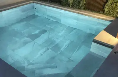 a swimming pool filled with blue water at Casa Pedro Luis in Conil de la Frontera