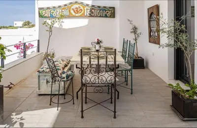 a table and chairs sitting on a balcony at Casa Pedro Luis in Conil de la Frontera