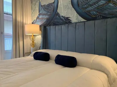 two beds in a hotel room with white sheets at San Francisco Centro in Cádiz