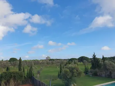 a green field with trees and a blue sky at Villa La Vida in Chiclana de la Frontera