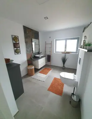 a bathroom with a toilet and a sink and a mirror at Villa La Vida in Chiclana de la Frontera