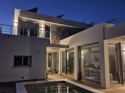 a house with a swimming pool in front of it at Villa La Vida in Chiclana de la Frontera