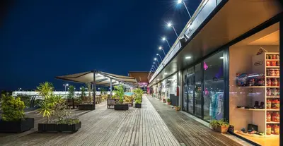 a building with a deck with plants and lights at Apartamento Las Olas de Valdelagrana in El Puerto de Santa María
