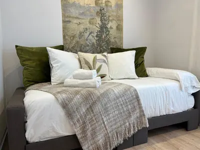 a bed with two towels on top of it at Hidden Gem. Capuchinos Boutique Homes in Cádiz