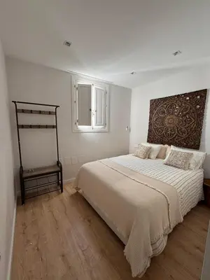 a white bedroom with a large bed and a window at Hidden Gem. Capuchinos Boutique Homes in Cádiz