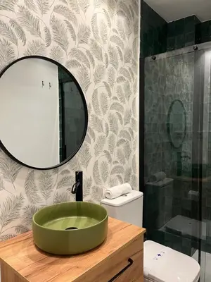 a bathroom with a green sink and a mirror at Hidden Gem. Capuchinos Boutique Homes in Cádiz