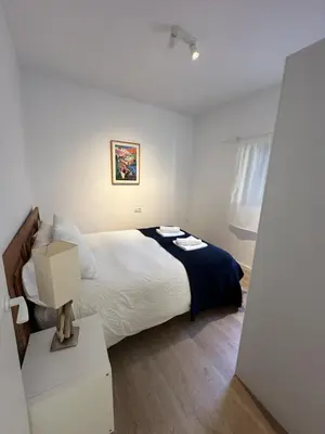 a bedroom with a large bed and a box at La Carabela, Elcano in Sanlúcar de Barrameda