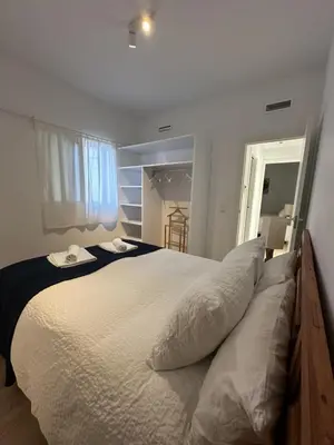 a bedroom with a large white bed with two pillows at La Carabela, Elcano in Sanlúcar de Barrameda