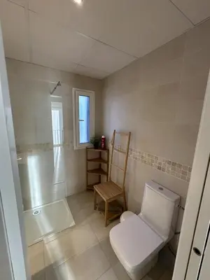 a bathroom with a toilet and a shower and a tub at La Carabela, Elcano in Sanlúcar de Barrameda