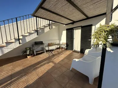 a balcony with a white chair and a staircase at La Carabela, Elcano in Sanlúcar de Barrameda