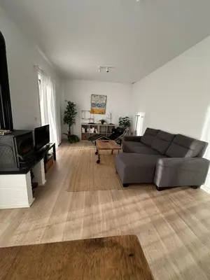 a living room with a couch and a tv at La Carabela, Elcano in Sanlúcar de Barrameda