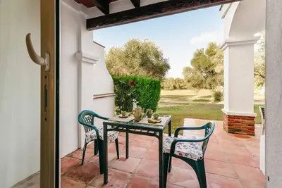 a patio with a table and chairs on a patio at Country Home in Arcos de la Frontera