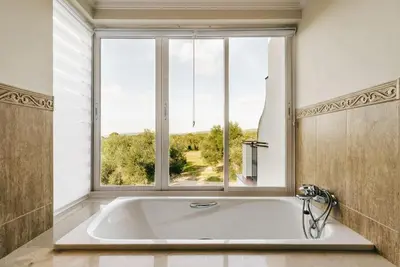 a bath tub in a bathroom with a window at Country Home in Arcos de la Frontera