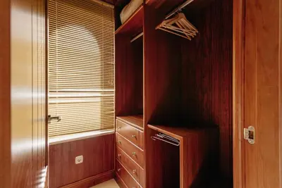 a walk in closet with wooden walls and a window at Country Home in Arcos de la Frontera