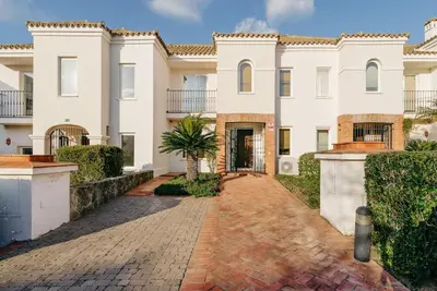 a large white house with a brick driveway at Country Home in Arcos de la Frontera