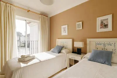 two beds in a bedroom with a window at Country Home in Arcos de la Frontera