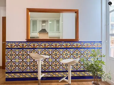 a blue wall with shelves with a plant on a table at Rym House Grupo AC Gestion in Cádiz