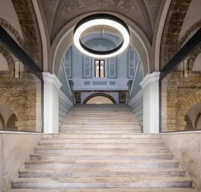 a staircase in a building with a large ceiling at Ático Sol in San Fernando