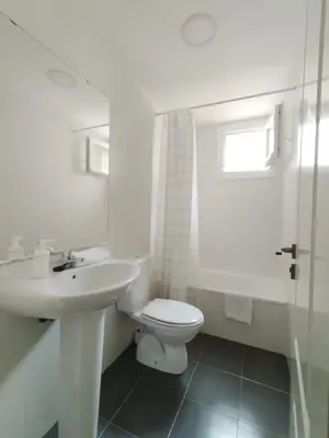 a white bathroom with a toilet and a sink at Ático Sol in San Fernando