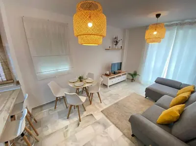 a living room with a couch and a table at Apartamento en centro con garaje in Sanlúcar de Barrameda