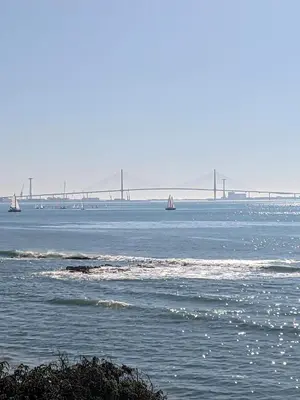 a large body of water with a bridge in the background at Adosada en El Puerto Santa María in El Puerto de Santa María