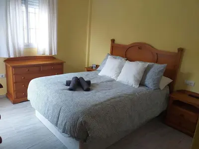 a bedroom with a bed with a teddy bear on it at Adosada en El Puerto Santa María in El Puerto de Santa María